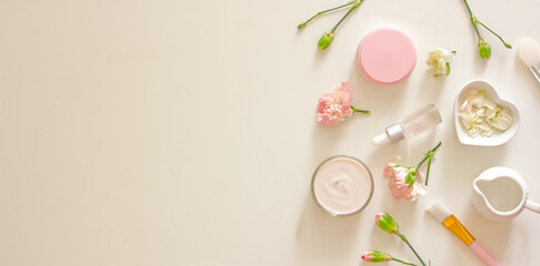 Natural cosmetics with floral scent on a pink background banner. Bath salt, aromatic bomb, oils,...