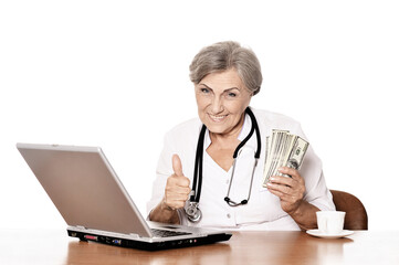  elderly woman holding dollars  with thumb up on white background