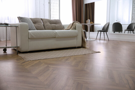Modern living room with parquet floor and stylish furniture