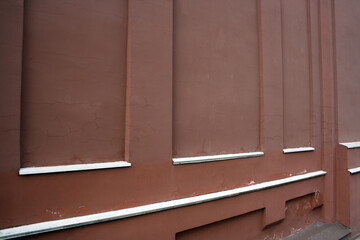 A wall of red plaster on the street. Old background. Space for the text.