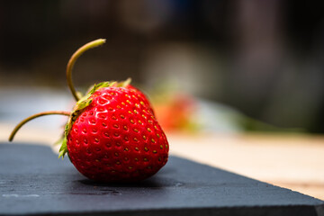 Close-up of fresh strawberry showing seeds achenes. Details of a fresh ripe red strawberry.