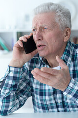 portrait of  senior man talking on phone