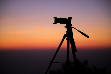 Silhouette of a camera on the tripod
