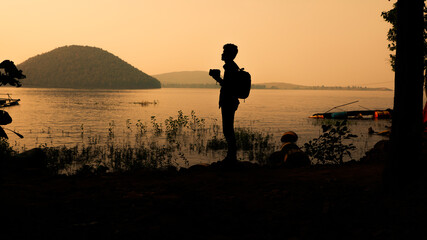 Silhouette of a lone photographer in nature