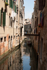 Obraz na płótnie Canvas A small backstreet canal in Venice in Italy
