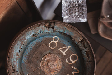 old blue drink barrel covered in dust on a wooden background