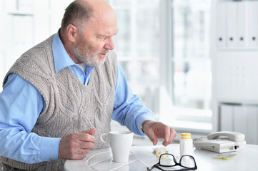 Portrait of sad sick senior man