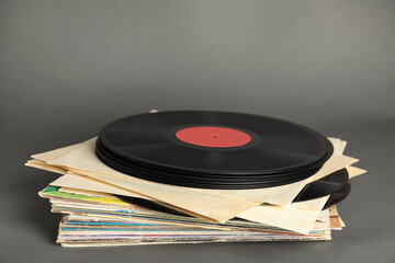 Fototapeta premium Stack of vintage vinyl records on grey background