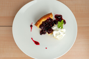 Cheesecake with blueberries from above on madrera background