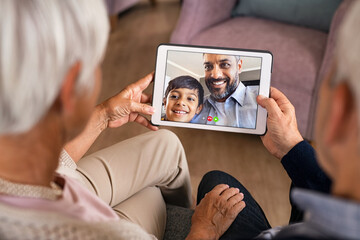 Family doing video call using digital tablet at home