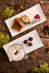 Irish coffee with grated dark chocolate on wooden table