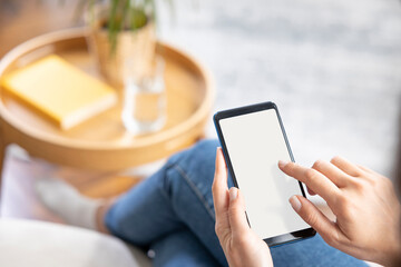 Young woman using smartphone at home