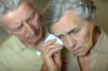 Portrait of sick  elderly woman and man  at home