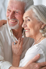  senior couple hugging at home