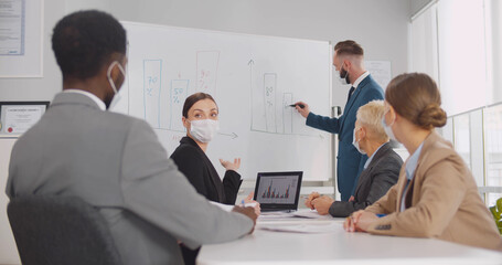 Diverse business team at training in medical face mask