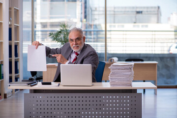 Aged businessman employee working in the office