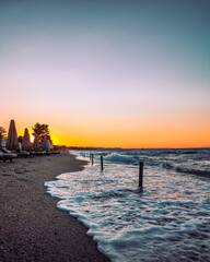 Warm colors of sunset at Chalkidiki Greece , the water is waving 