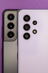 Grey and violet smartphones on purple background