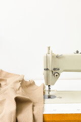 Sewing machine and fabric on a light background