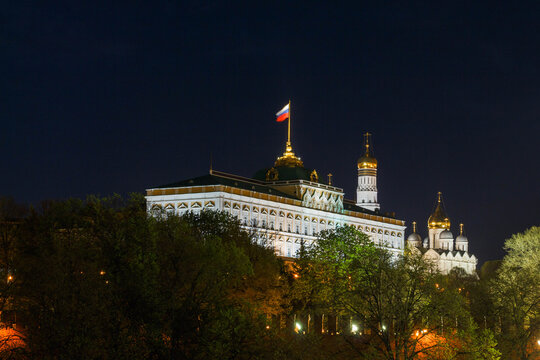 Moscow, Russia. Night view of Great Kremlin palace surrounded by trees. Ivan the Great bell tower in background