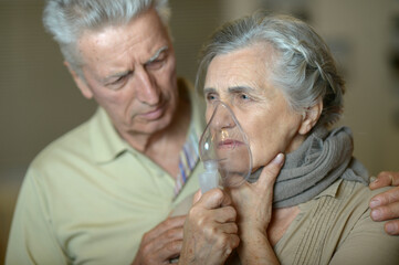 Close-up portrait of an elder couple  making inhalation