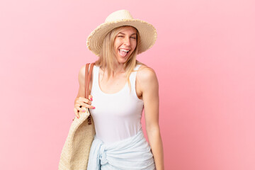 young blonde woman with cheerful and rebellious attitude, joking and sticking tongue out. summer...