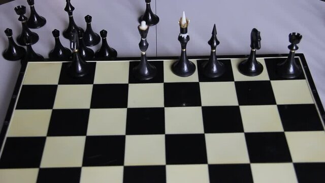 a child plays chess puts chess on a chessboard