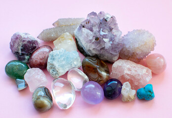 Tumbled and rough gemstones and crystals of various colors. Amethyst, rose quartz, agate, apatite,...