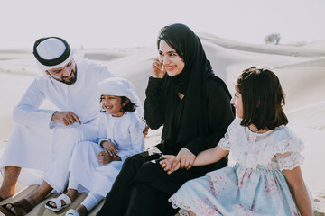 Happy family spending a wonderful day in the desert making a picnic