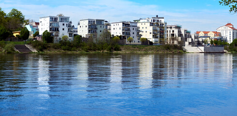 View over the river Elbe in Magdeburg with modern residential buildings on the bank of the blue...