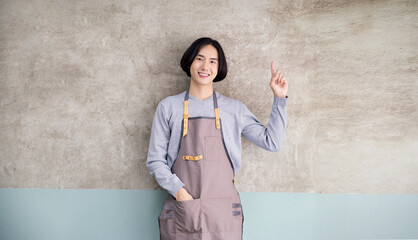 Startup successful small business owner man point up in coffee shop restaurant with copy space. Portrait of young asian man successful barista cafe local owner seller sme service job, unisex concept