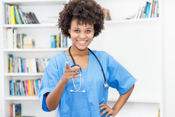 Laughing afro american female nurse ready for vaccinating patients