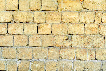 Texture of a brick wall with cracks and scratches which can be used as a background