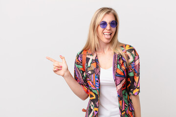 young blonde woman with cheerful and rebellious attitude, joking and sticking tongue out. summer...