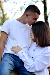 amorous young couple in white shirts hugging