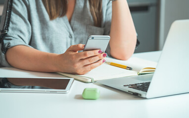 Unrecognizable Businesswoman Having Break and Using her Mobile Phone to Send Text Message or Call...