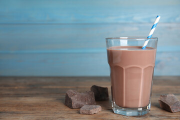 Delicious chocolate milk on wooden table. Space for text