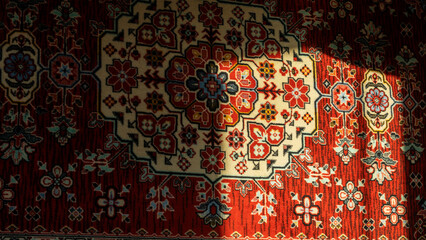 Manufactory carpet with sun spot on the wall. Texture and background for design. Space for text.