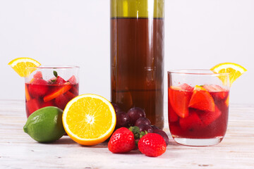 Cocktail drink-orange juice fresh juice with strawberry with lemon orange, mango, pineapple, apple, grapes isolated on white background. High-resolution image