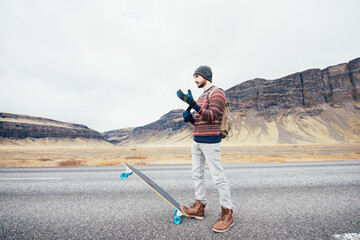 Skater traveling iceland on his longboard