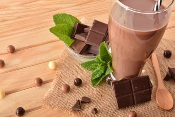 Zelfklevend Fotobehang Glass with milk chocolate shake on wooden table elevated view © Davizro Photography