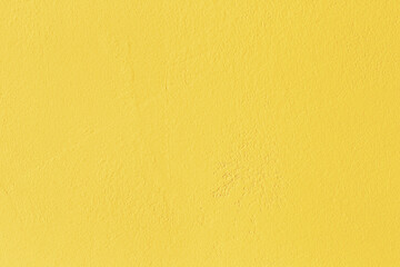 Abstract grunge yellow background with plaster texture in warm mood. Background with color of the year with space for text. 