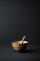 Traditional, handcrafted ceramic on dark background. Soft focus. Copy space.