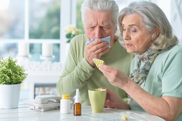 ill Senior couple with pills