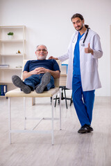 Old male patient visiting young male doctor chiropractor