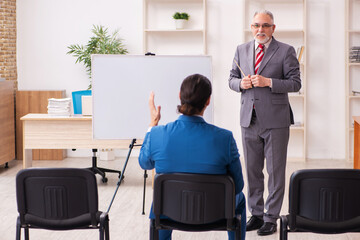 Two male employees in business meeting concept