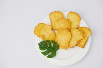 Crispy garlic bread on white plate on white background