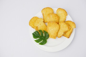 Crispy garlic bread on white on white background