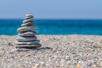Tower of stones in the beach. Vertical. Selective focus