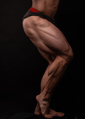Fototapeta na wymiar Muscled male legs on isolated background